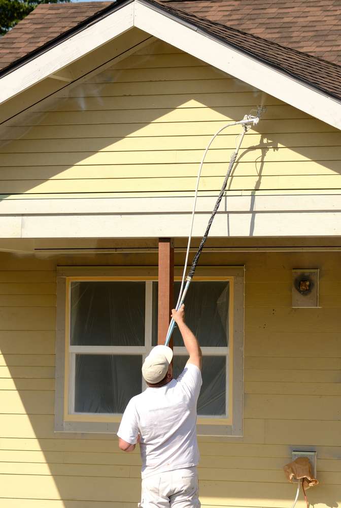 Exterior painting services spraying process.